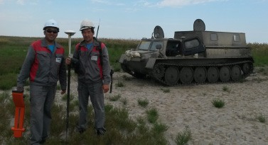 Field crew beside a tracked survey vehicle