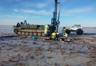 Field crew drilling in snowy open terrain